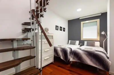 a bedroom with a large bed and a large window at The Collection Barcelona - Plaça Catalunya 3bedroom Duplex with Balcony in Barcelona