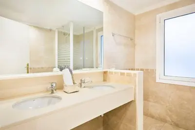 a bedroom with a bed with two towels on it at The Collection Barcelona - Central and Elegant 4 Bedroom by Placa Catalunya in Barcelona