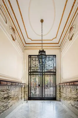 a kitchen with wooden cabinets and a stove top oven at The Collection Barcelona - Ronda Sant Pere Private City Center 3Bedroom Suite B in Barcelona
