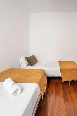 a bedroom with a large bed and two windows at The Collection Barcelona - Ronda Sant Pere Private City Center 3Bedroom Suite B in Barcelona