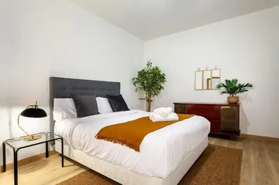 a bedroom with a bed and a desk with towels at The Collection Barcelona - Exclusive Huge 4 Double Bedroom City Center in Barcelona