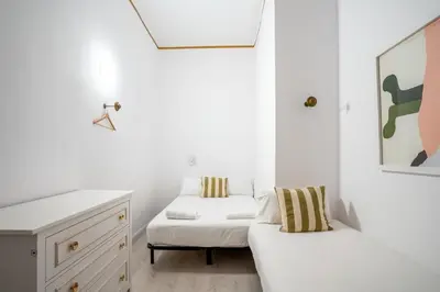 a hallway with a white door and a checkered floor at The Collection Barcelona - Placa Catalunya V Charming and Exquisite 5Bd Apartment with Large Balcony in Barcelona