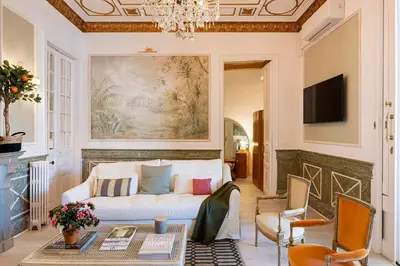 a balcony with a table and chairs and a window at The Collection Barcelona - Placa Catalunya V Charming and Exquisite 5Bd Apartment with Large Balcony in Barcelona