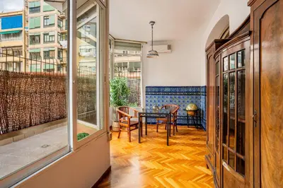 a room with a table and chairs and a balcony at The Collection Barcelona - Huge historic 5BD with private Terrace! in Barcelona
