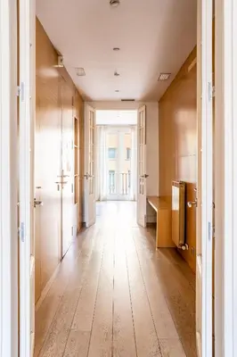 an empty hallway with wooden floors in a building at The Collection Barcelona - Classy 3bed 3bath apartment in Eixample in Barcelona