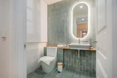a bathroom with a sink and a toilet and a mirror at The Collection Barcelona - Amazing 5 bd 5 bathroom next to Plaza Catalunya in Barcelona