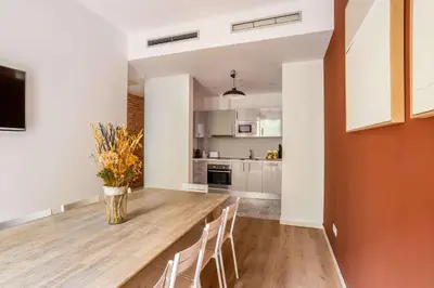 a kitchen and dining room with a wooden table and chairs at The Collection Barcelona - Perfectly located 4bed 4bath apartment in Eixample in Barcelona