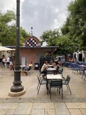a group of tables and chairs and a light pole at Apartamento ático en el casco antiguo in Mataró