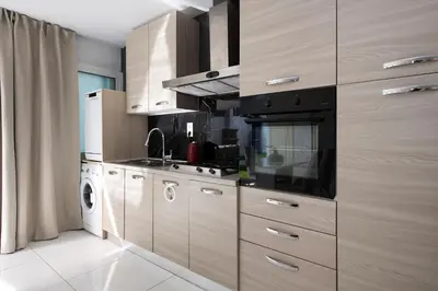 a kitchen with a stove and a washer and dryer at PLAYA a 3 minutos Parking barbacoa Apartamento en Castelldefels in Castelldefels