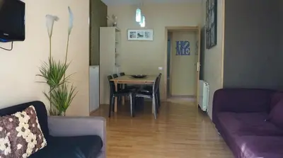a living room with a couch and a dining room table at GOOD APARTMENTS gran via 3 bedrooms in Barcelona