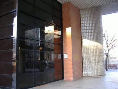 a large glass building with a large glass door at GOOD APARTMENTS gran via 3 bedrooms in Barcelona