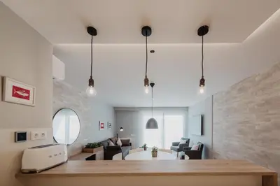 a living room with a table and some chairs at Petit Luxe Volta Apartaments in Terrassa