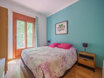 a bedroom with a bed with pink pillows and a window at Absolute Sagrada Familia in Barcelona