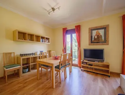 a dining room with a table and a television at Absolute Sagrada Familia in Barcelona