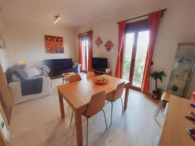 a living room with a wooden table and chairs at Absolute Sagrada Familia in Barcelona