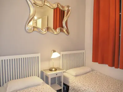 a bedroom with two beds and a mirror on the wall at Whatching Sagrada Familia in Barcelona