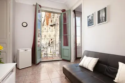 a living room with a couch and a large window at Whatching Sagrada Familia in Barcelona