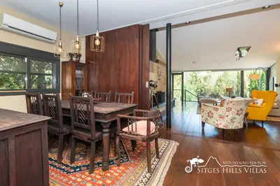 a living room with a couch and a table at Spacious Villa Santa Fe - private pool, big garden and A/C close to Sitges in Olivella