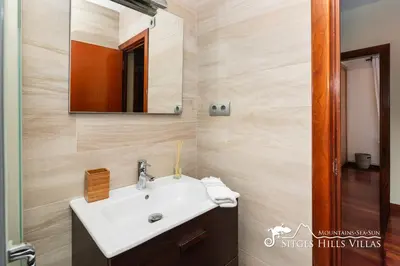 a bathroom with a sink and a mirror at Spacious Villa Santa Fe - private pool, big garden and A/C close to Sitges in Olivella