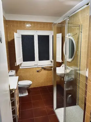 a bathroom with a toilet and a sink and a shower at Casa iaia in Monistrol