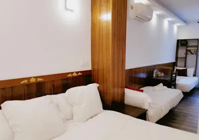 a hotel room with two beds and a mirror at Barcelona CoronaHostal in Badalona