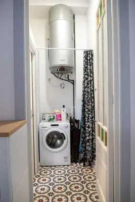 a laundry room with a washing machine in a hallway at Hauzify I Apartament Can Missé in Calella