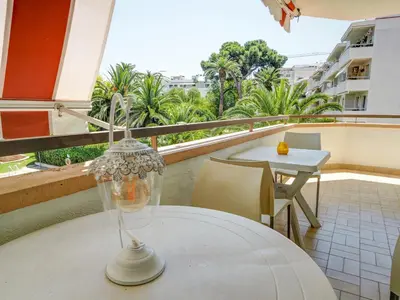 a white table with a glass vase on a balcony at Clarimar Beach Apartment by Hello Homes Sitges in Sitges