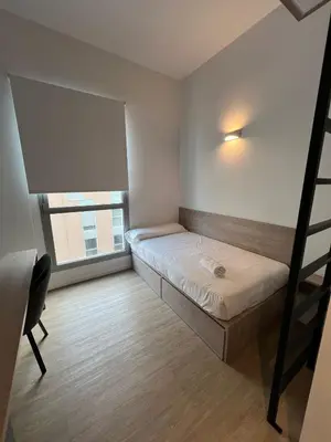 a small bedroom with a bunk bed and a window at Micampus Barcelona Student Residence in Barcelona