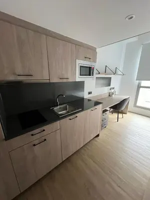 a kitchen with a sink and a microwave at Micampus Barcelona Student Residence in Barcelona