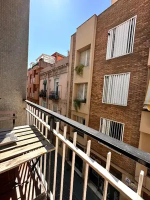 a balcony with a wooden bench and buildings at Gracia Barcelona Apartment in Barcelona