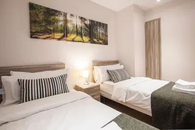 a bedroom with two beds and a painting on the wall at Tendency Apartments 6 in Barcelona