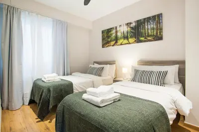 a hotel room with two beds and two tables at Tendency Apartments 6 in Barcelona