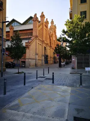 an empty street with a large brick building at ApartEasy - Atic Sants in Barcelona