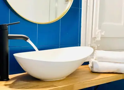 a bathroom with a white bowl sink and a mirror at LEPANTO APARTMENTS 150m FROM SAGRADA FAMILIA in Barcelona