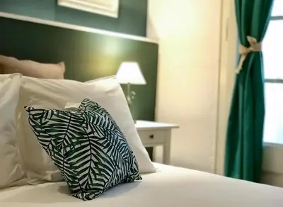 a bed with a black and white pillow on it at LEPANTO APARTMENTS 150m FROM SAGRADA FAMILIA in Barcelona
