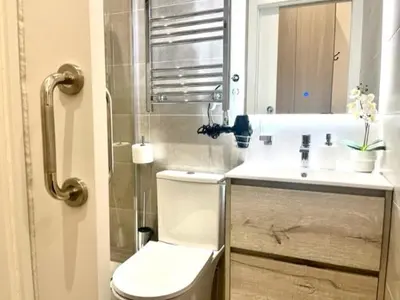 a bathroom with a toilet and a sink at Front Arc in Barcelona