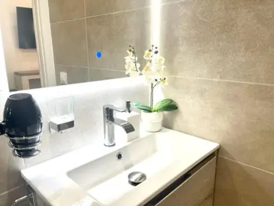 a bathroom with a sink and a mirror at Front Arc in Barcelona