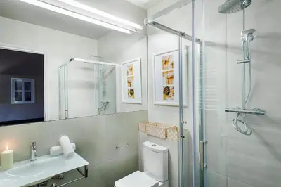 a bathroom with a shower and a toilet and a sink at BacHome Gallery B&B in Barcelona