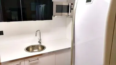 a kitchen with a sink and a refrigerator at La Fira in Barcelona