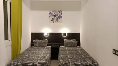 two beds in a room with green and white walls at Molino Fresh in Barcelona