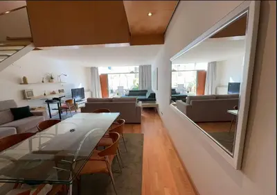 a living room with a table and chairs and a living room at Modernismo Paseo de Gracia in Barcelona