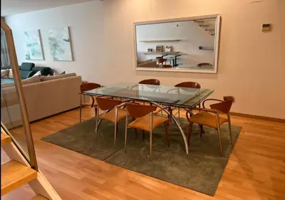 a dining room with a glass table and chairs at Modernismo Paseo de Gracia in Barcelona