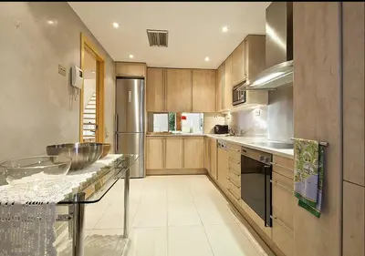 a large kitchen with wooden cabinets and a counter top at Modernismo Paseo de Gracia in Barcelona