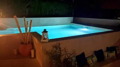 a large swimming pool with a light in the middle at Ca la Carmeta in Cunit
