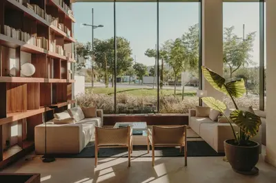 a living room with a couch and chairs and a large window at Sabàtic Sitges Hotel, Autograph Collection in Sitges