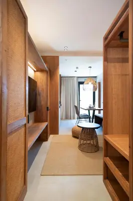 a living room with a table and a television at Apartamentos Balisse in Castelldefels