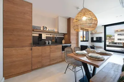 a kitchen and dining room with a table and chairs at Apartamentos Balisse in Castelldefels