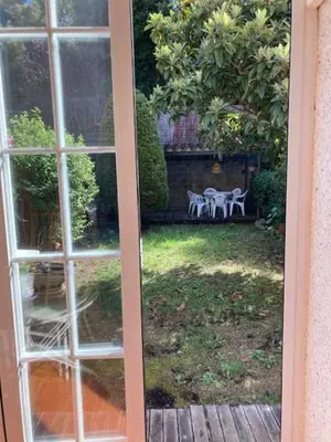 a view of a garden through a sliding glass door at VACACIONES EN MARESME CASA PARA 7 PERSONAS in Sant Iscle de Vallalta