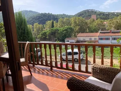 a balcony with a view of a car parked in a parking lot at VACACIONES EN MARESME CASA PARA 7 PERSONAS in Sant Iscle de Vallalta