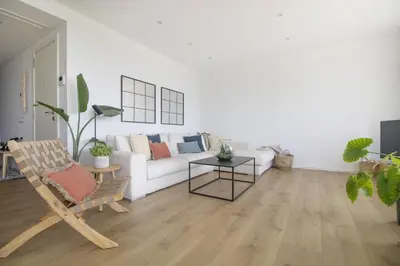 a living room with a white couch and a table at Vivalidays Apartour - Calella in Calella